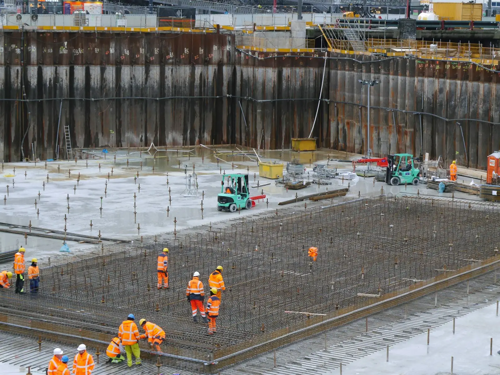 Wide view of an active construction site with crews at work