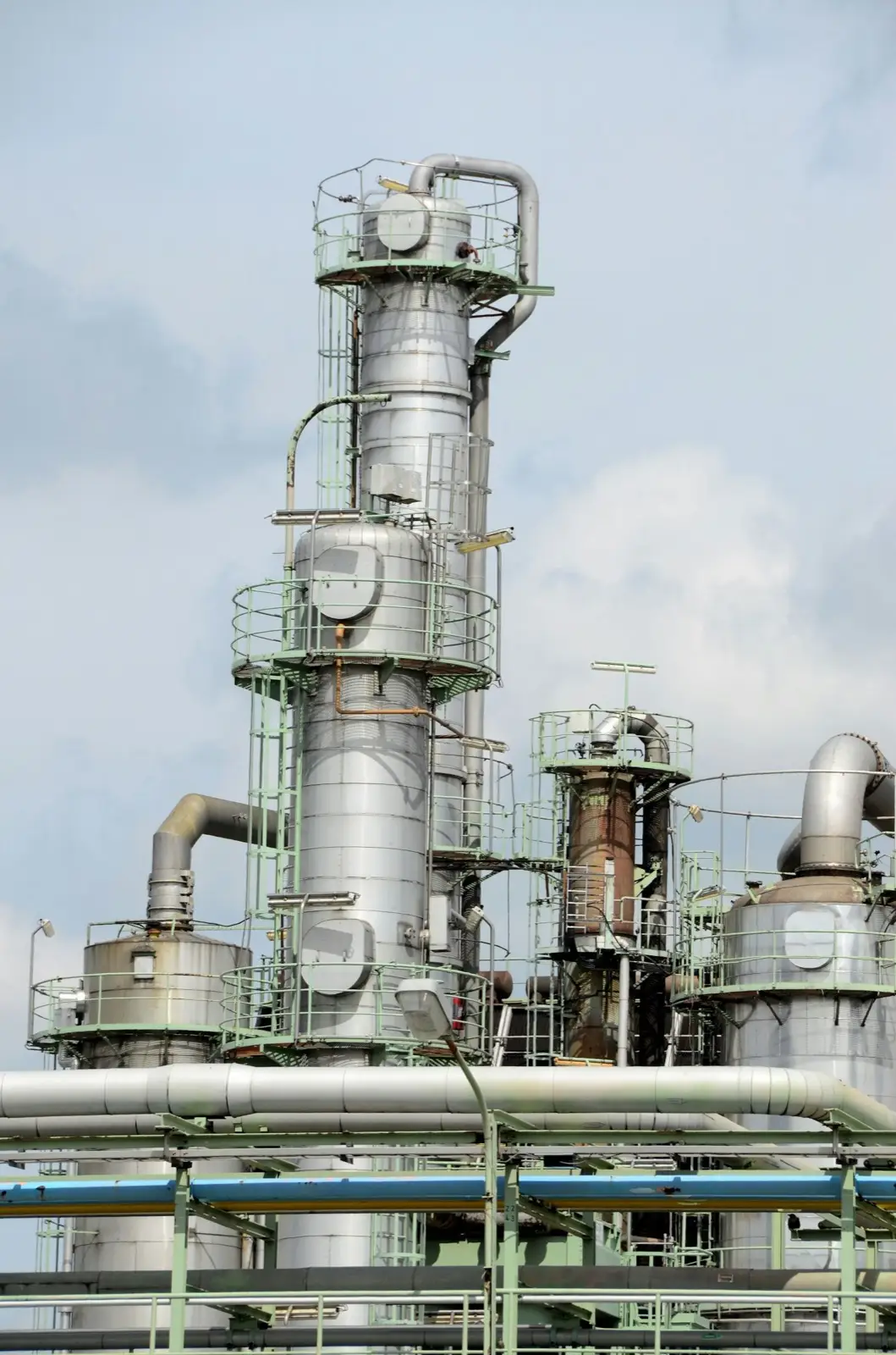 Process towers and piping at an industrial plant