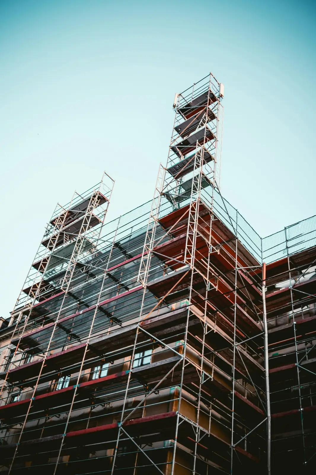 Scaffold rising several lifts along the facade of a commercial building