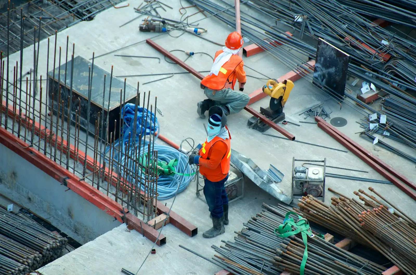 Crew working with materials on an open construction deck